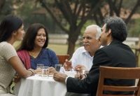 family having meal outdoors - Manoj Adhikari