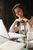 business woman working at laptop, smiling - Alex Mares-Manton