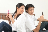 Couple texting each other - Deepak Budhraja