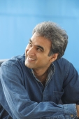 Man with gray hair, looking off and smiling - Manoj Adhikari