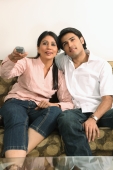 Husband and wife watching tv - Deepak Budhraja