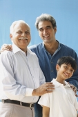 Grandfather, father, son all smiling at camera (vertical) - Manoj Adhikari