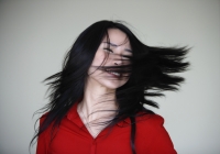 woman swinging her hair over her face - Yukmin