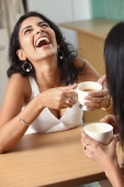 two young woman having coffee - Vivek Sharma