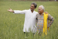 father and son farmers in field - Manoj Adhikari