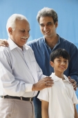 Grandfather, father & son, grandfather with hands on grandson's shoulders - Manoj Adhikari
