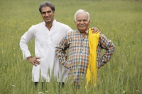 father and son farmers in field - Manoj Adhikari
