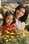 mother and daughter with flowers, smiling at camera - Alex Mares-Manton
