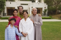 family in front of home - Manoj Adhikari
