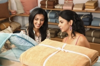 two women shopping for household items - Vivek Sharma