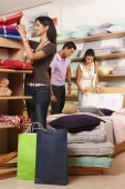 three people shopping in fabric store - Vivek Sharma