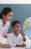 teacher and student look at globe - Alex Mares-Manton