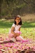 young girl kneeling in park - Deepak Budhraja