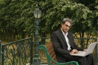 man with laptop on bench - Manoj Adhikari
