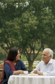 senior couple having coffee outdoors - Manoj Adhikari