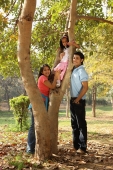 Parents at park, daughter in tree - Deepak Budhraja