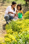 Mother and daughter with green pail - Deepak Budhraja