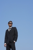 man in dark suit, dark glasses - Alex Mares-Manton