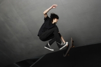 young man in mid air with skateboard - Yukmin