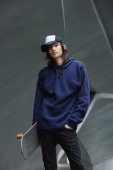 young man holding skateboard - Yukmin