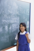 girl in front of chalkboard smiling - Alex Mares-Manton