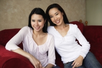 two woman smiling on couch - Yukmin