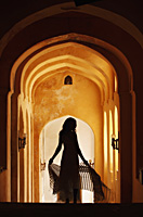 silhouette of woman in arched hallway - Vivek Sharma