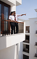 young couple on balcony - Alex Mares-Manton