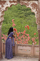 young woman in sari look out from balcony - Alex Mares-Manton