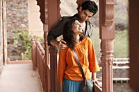 couple standing on balcony - Vivek Sharma