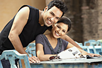 couple smiling with newspaper - Vivek Sharma