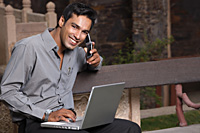 man on phone, with laptop computer - Vivek Sharma