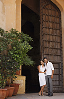 couple standing in giant doorway - Vivek Sharma