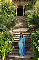 young woman in sari, on steps - Alex Mares-Manton