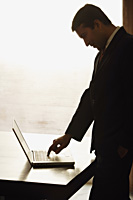 businessman working on laptop computer - Alex Mares-Manton