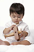baby boy playing with toy airplane - Alex Mares-Manton
