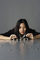 young lady sitting counting coins - Yukmin