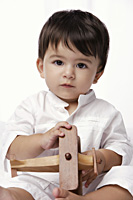baby boy holding toy airplane - Alex Mares-Manton