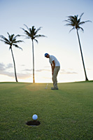 man playing golf during sunset - Yukmin