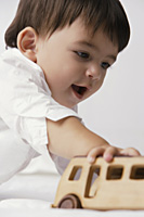 baby boy playing with toy auto - Alex Mares-Manton