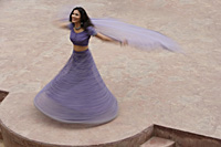 young woman in sari, dancing on patio - Alex Mares-Manton