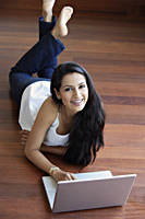 young woman on floor using laptop - Alex Mares-Manton