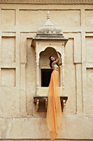 young woman in sari, on balcony - Alex Mares-Manton