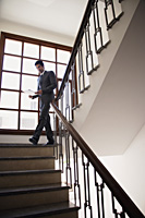 businessman walking down the stairs - Alex Mares-Manton