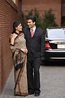 couple in front of car, woman in sari - Alex Mares-Manton