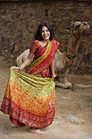 young woman in sari, in front of camel - Alex Mares-Manton