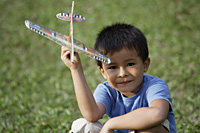 boy holding toy airplane - Yukmin