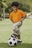 little boy with foot on soccer ball - Vivek Sharma