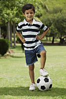 little boy with foot on soccer ball - Vivek Sharma