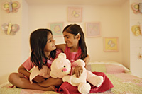 little girls with stuff bears on bed - Alex Mares-Manton